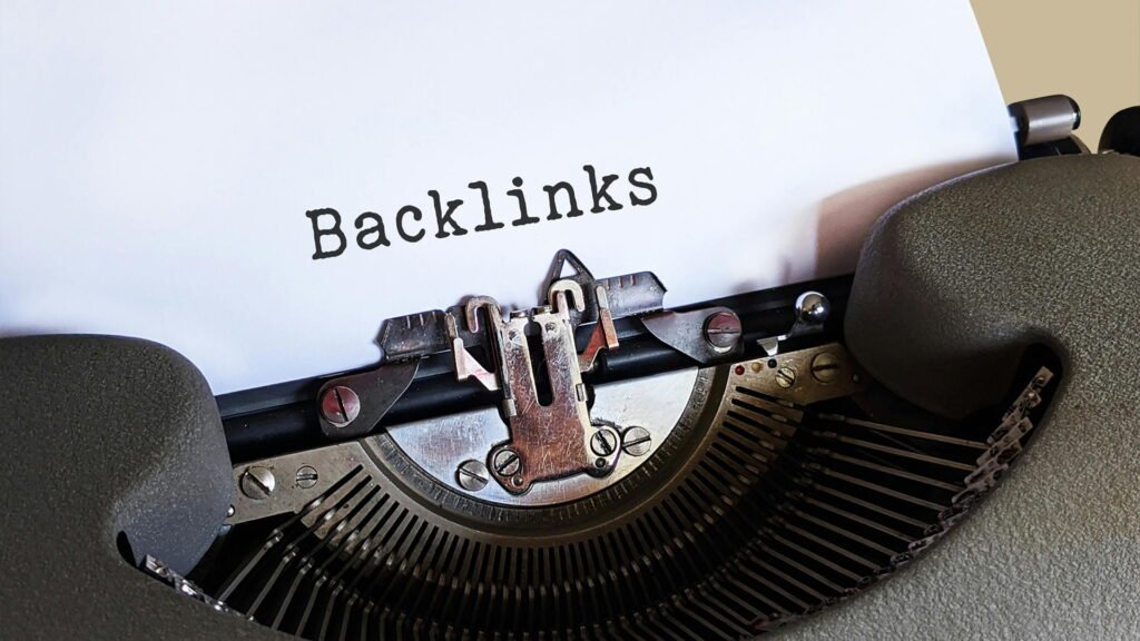 Backlinks text typed on a vintage typewriter symbolizing off-page SEO, link building, and website authority growth in search engine rankings.
