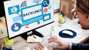 Person working on computer displaying backlinks concept on screen, representing backlink building strategy and SEO link building