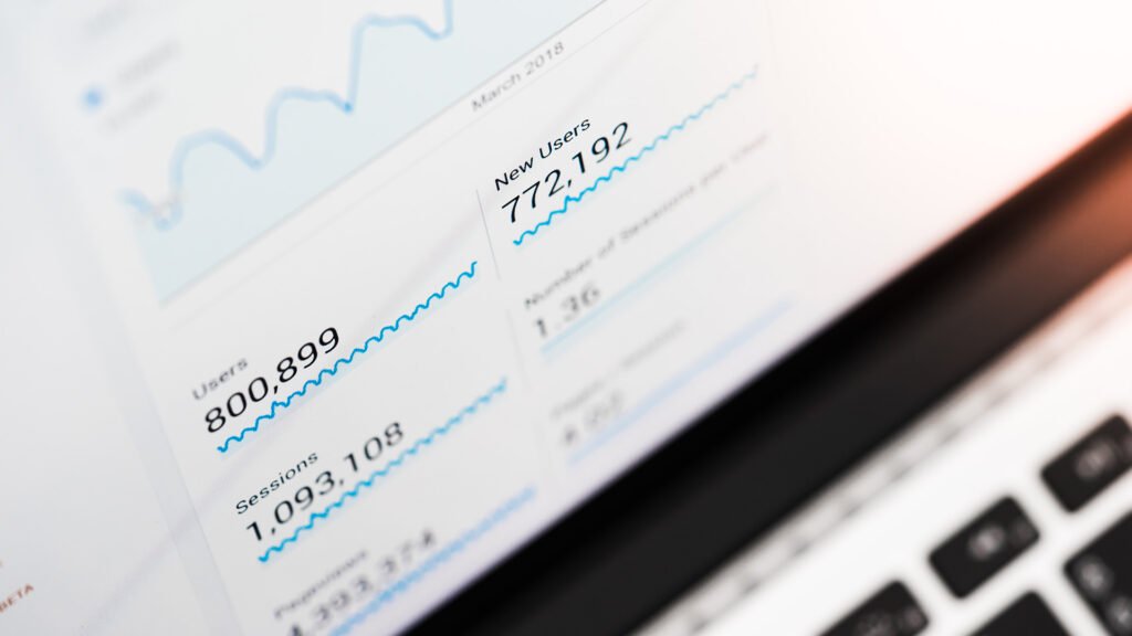  A close‑up of a monitor displaying a line graph with fluctuating activity and numerical metrics, symbolizing user engagement and performance tracking.