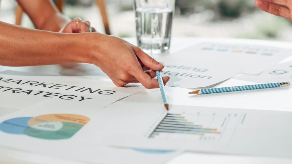 Business team reviewing an SEO marketing strategy with charts, reports, and analytics data to improve website traffic and online growth.
