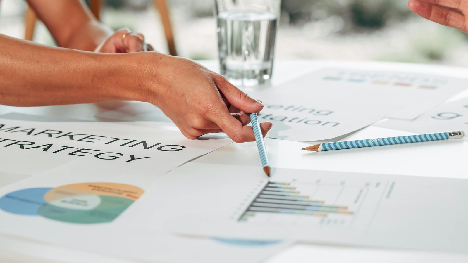 Business team reviewing an SEO marketing strategy with charts, reports, and analytics data to improve website traffic and online growth.